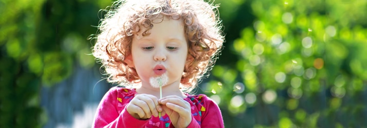 child with dandelion